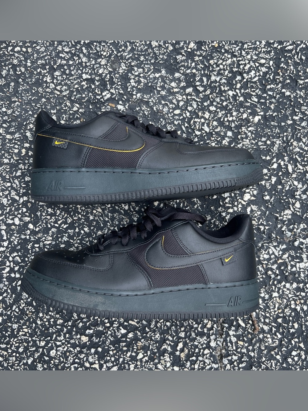 Nike Black Low-Top Sneakers with Yellow Swoosh Detail